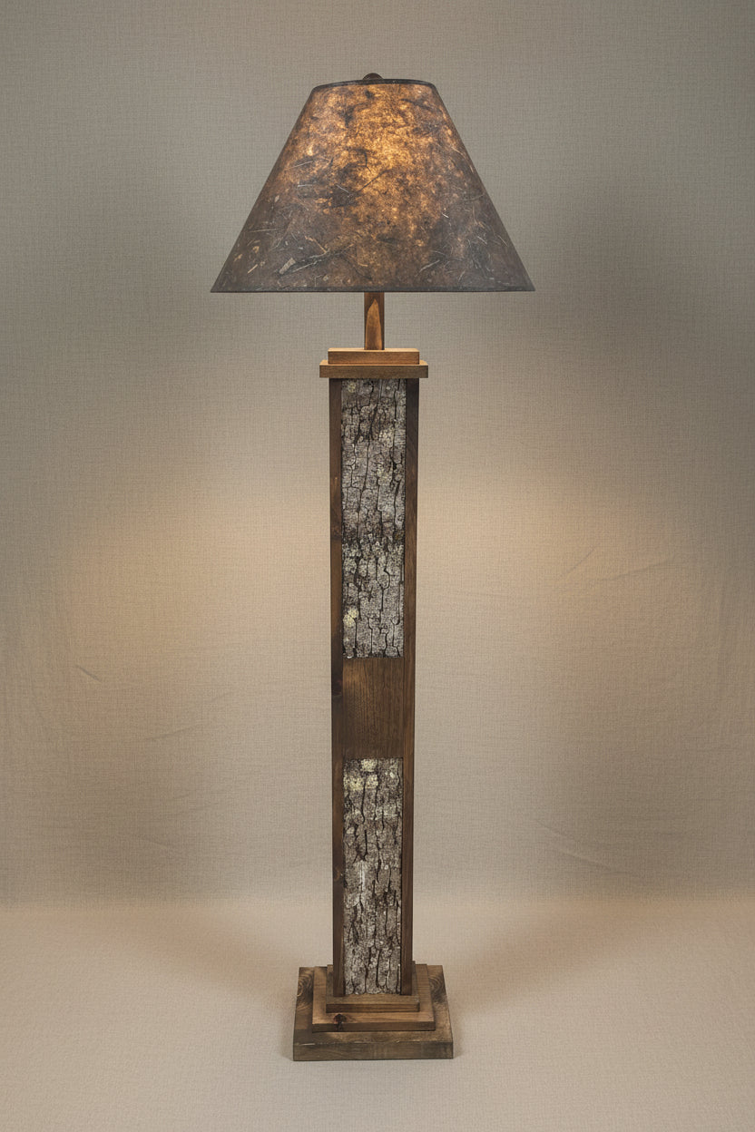 Floor lamp with rustic wooden base and dark lampshade on a white background