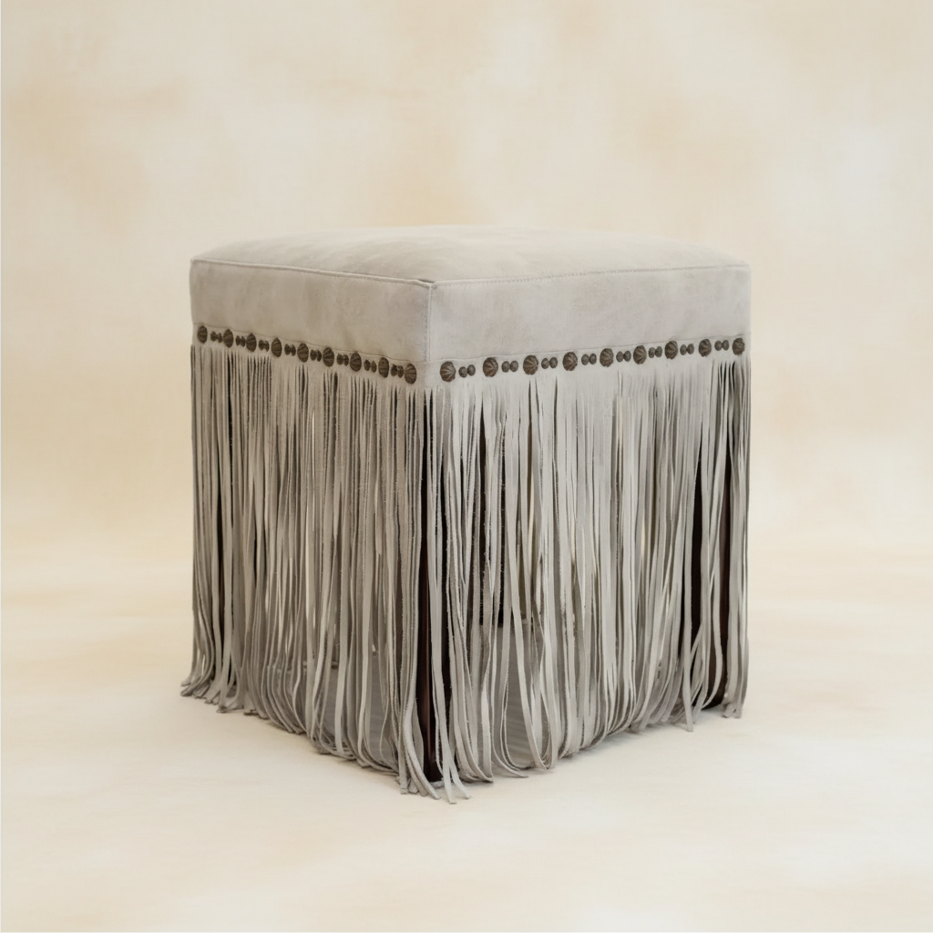custom square fringed ottoman in pale gray suede with custom clavos for modern ranch living