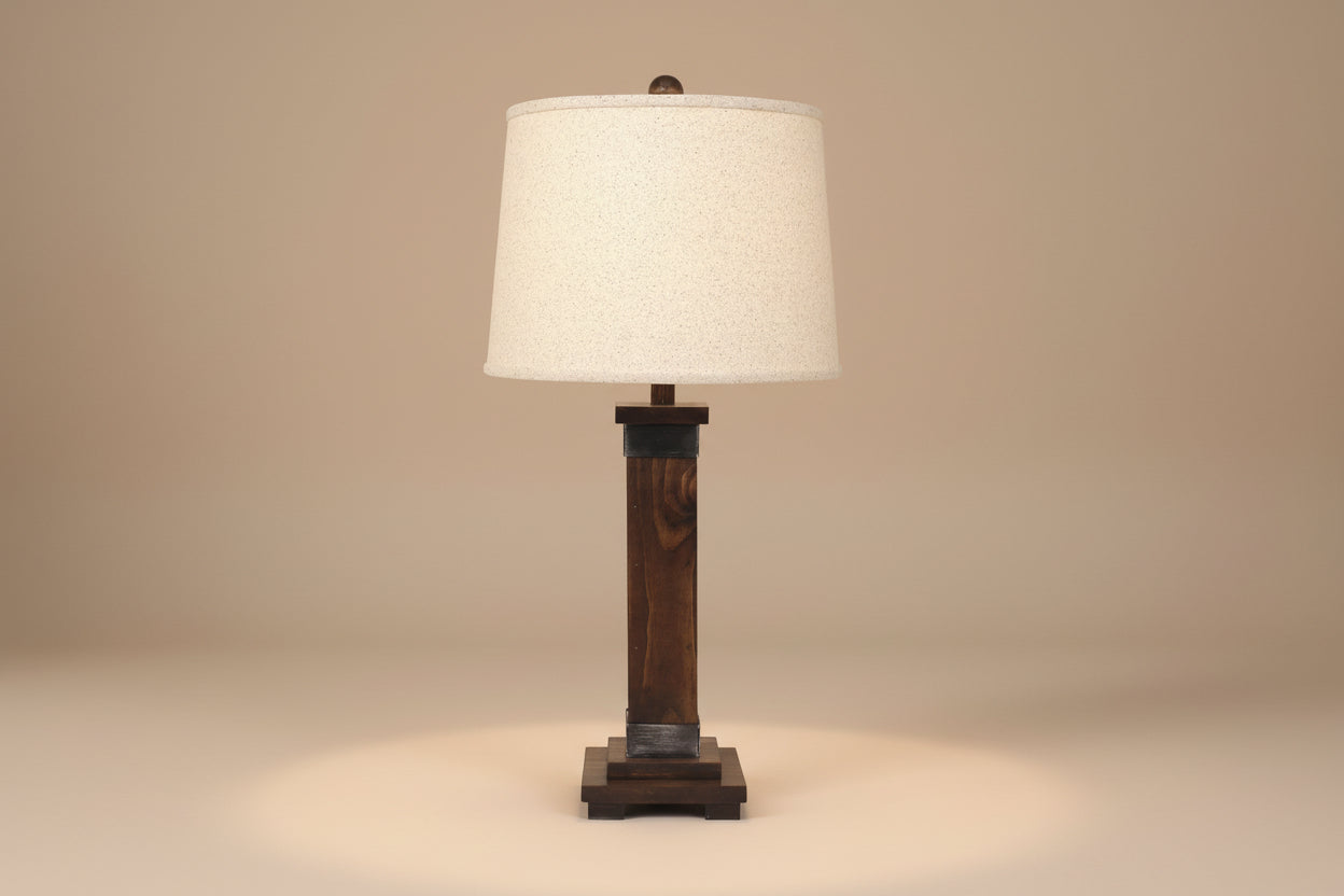 Table lamp with wooden base and beige shade on a white background