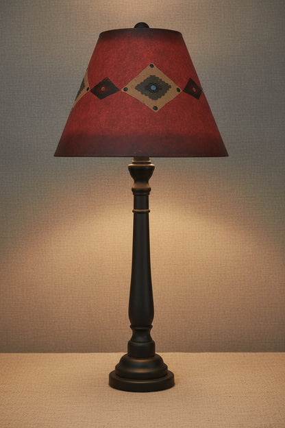 Table lamp with a red lampshade featuring geometric patterns on a white background