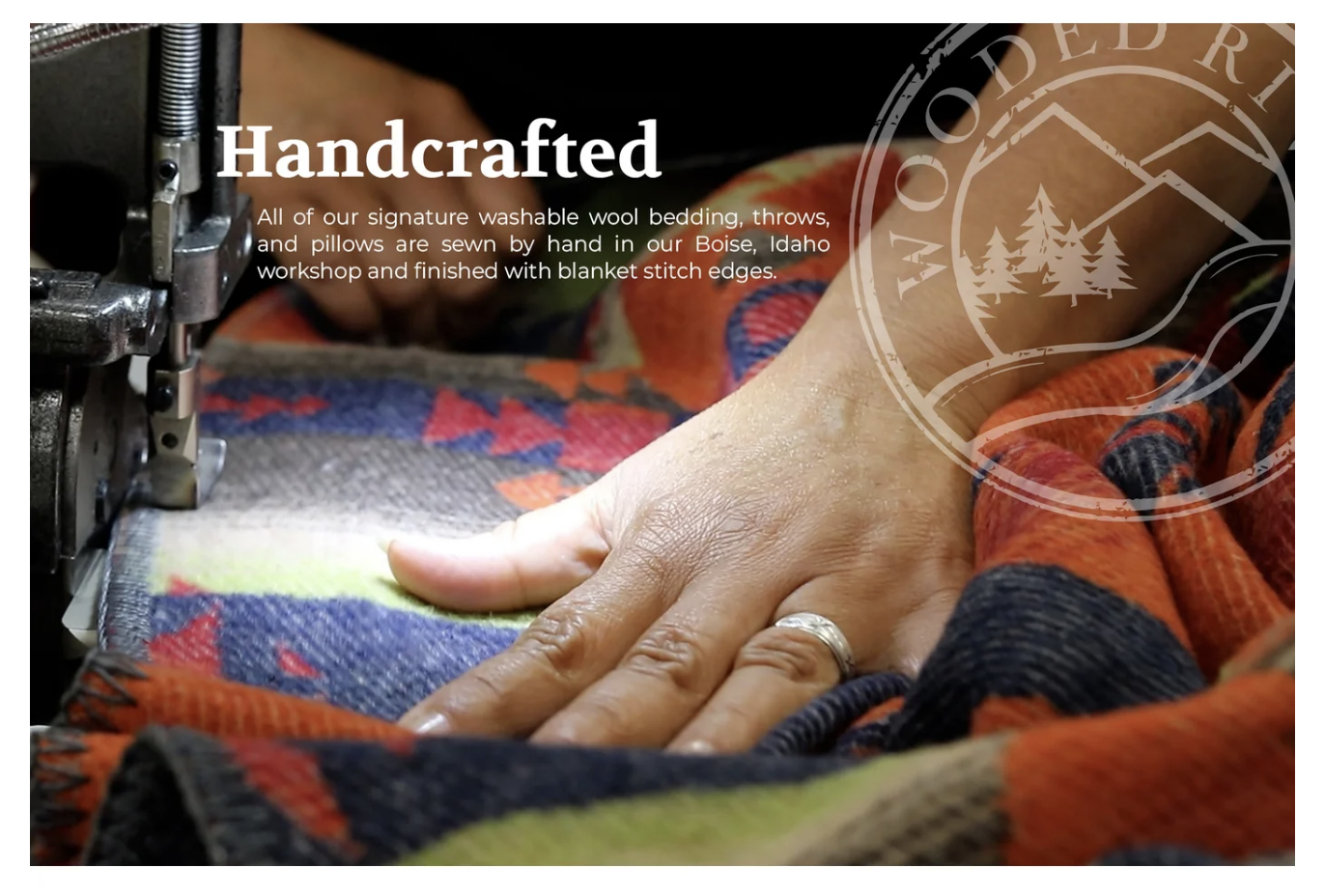 closeup of woman's hands sewing a blanket with the word "Handcrafted" above it