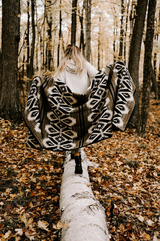 girl holding quichua blanket in onyx