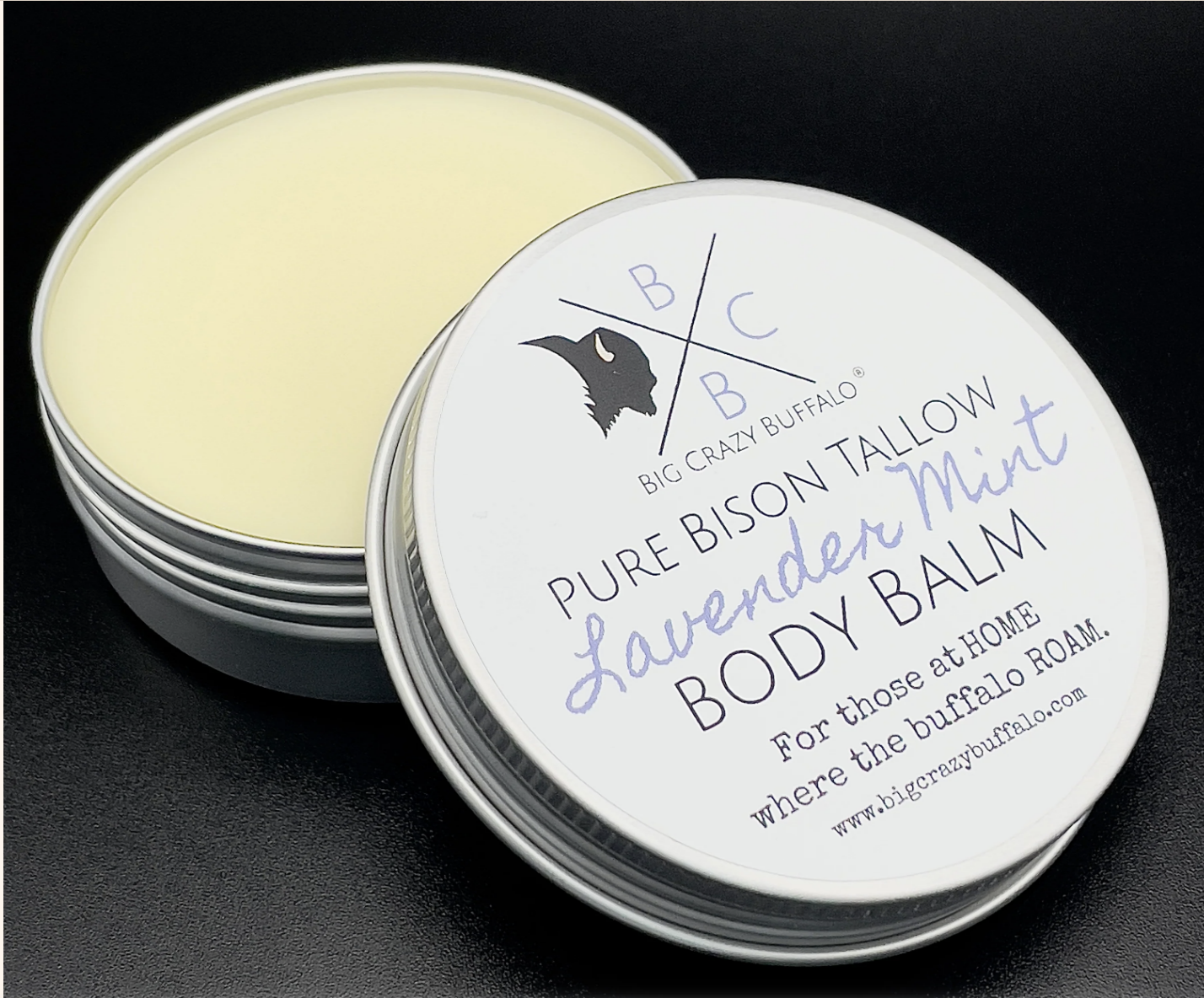 Open can of lavender mint body balm on black background